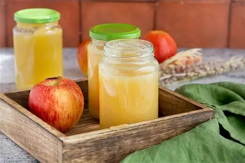 Cocine puré de manzana en frascos con tapa de rosca