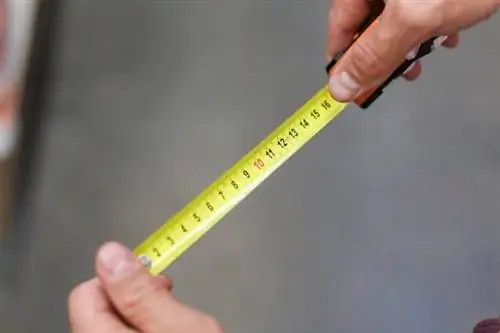 Hands hold measuring tape